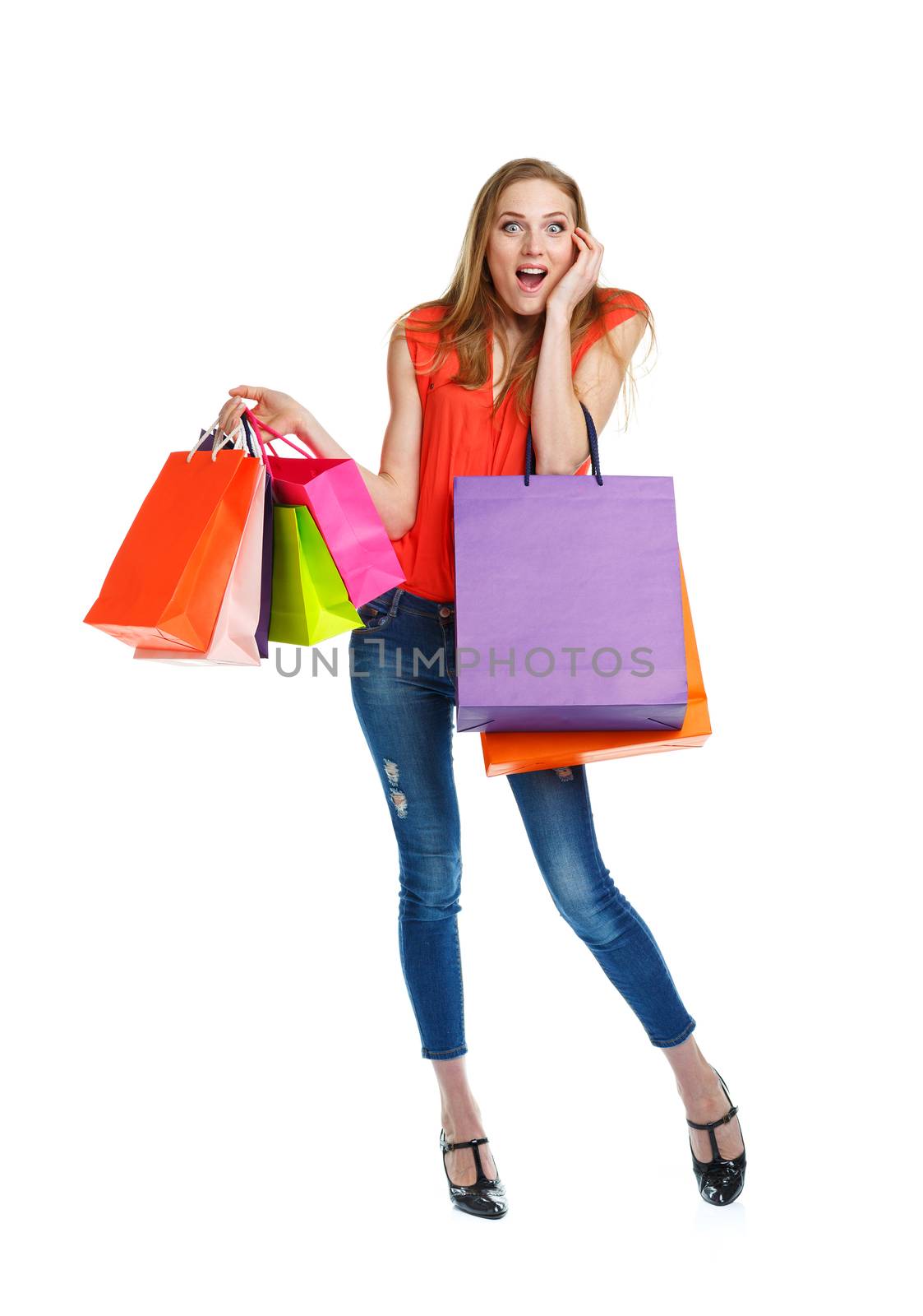 Happy lovely woman with shopping bags over white background