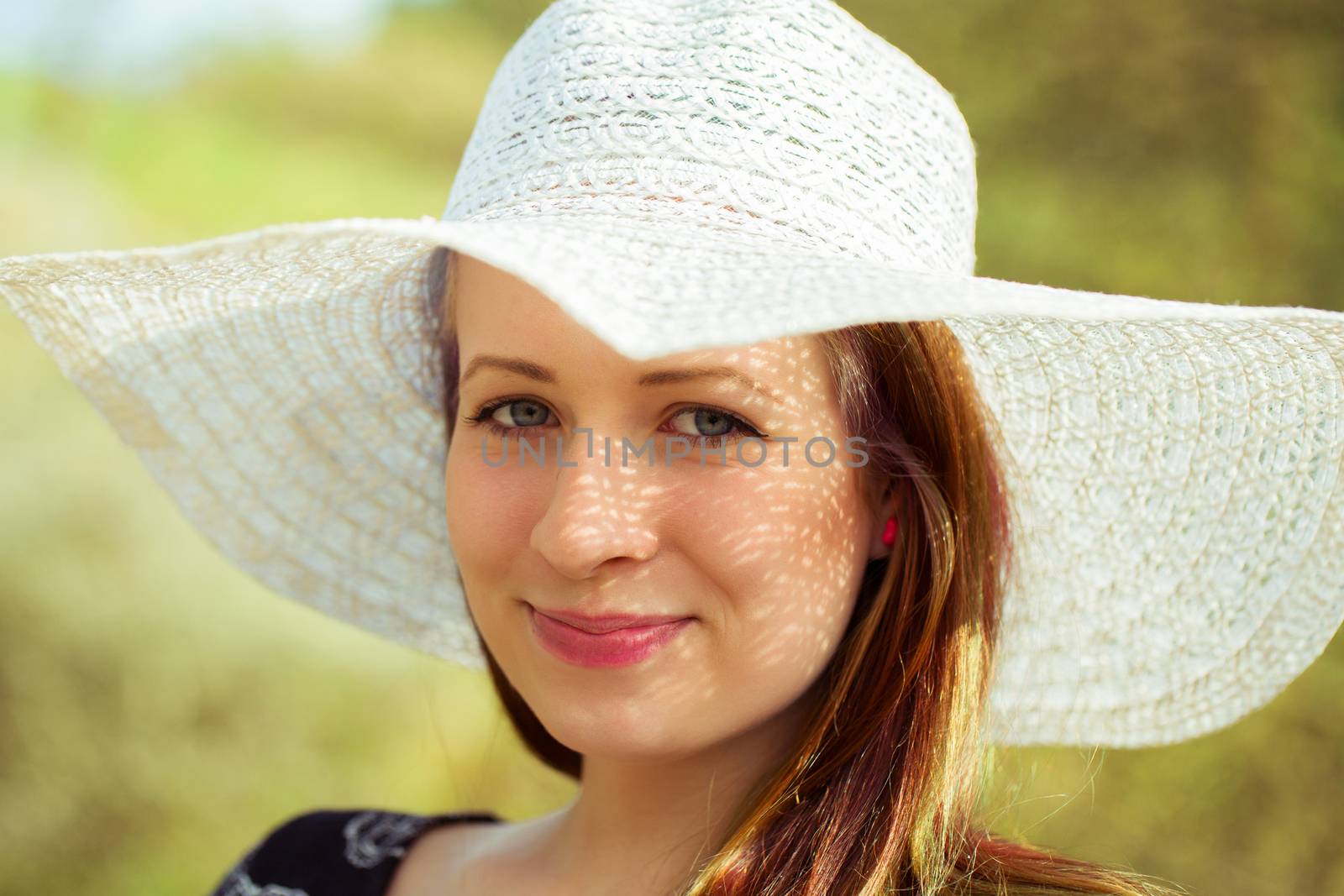 Portrait of cheerful fashionable woman in stylish hat by artush