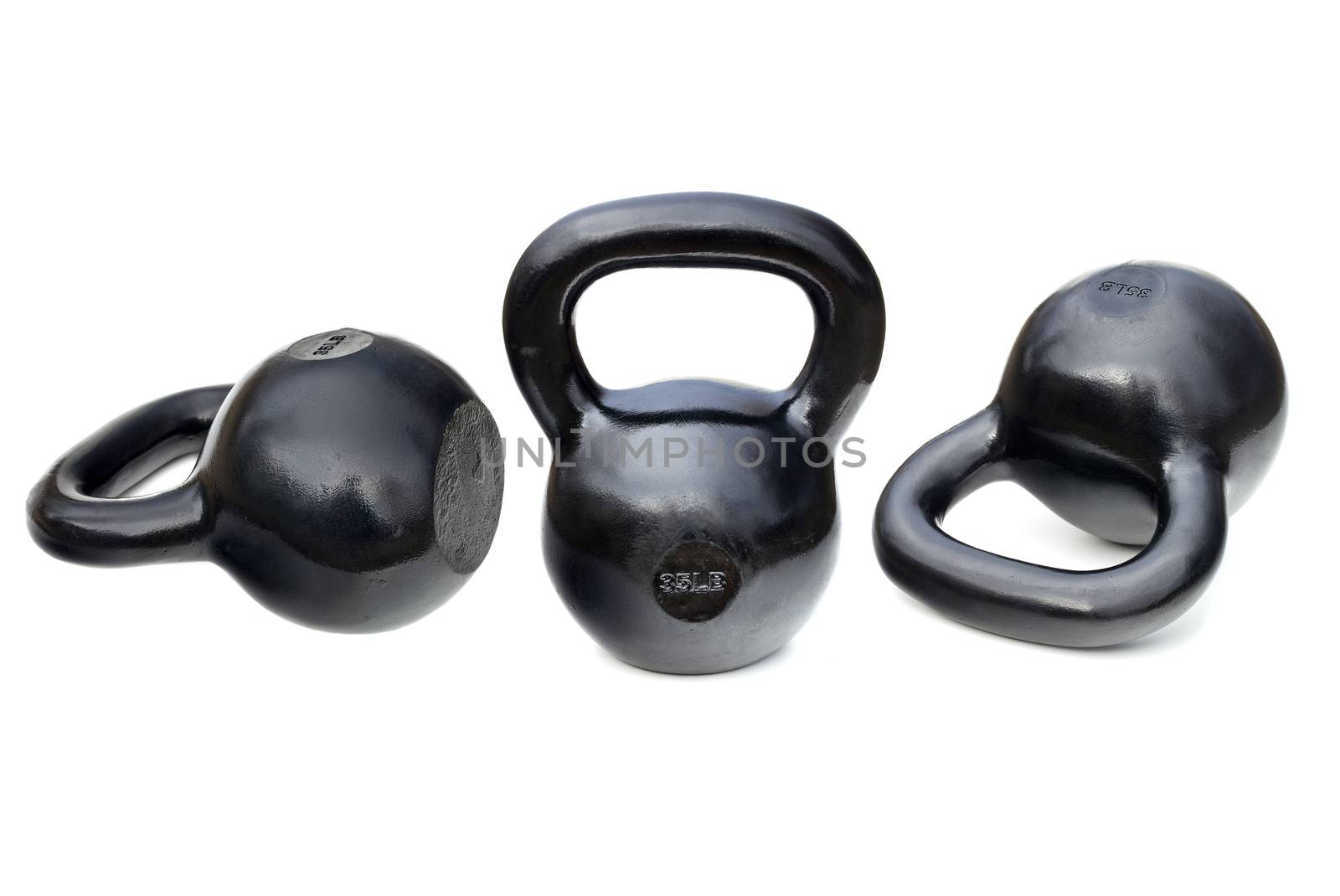 three black shiny 35 lb iron kettlebells for weightlifting and fitness  training isolated on white with clipping paths