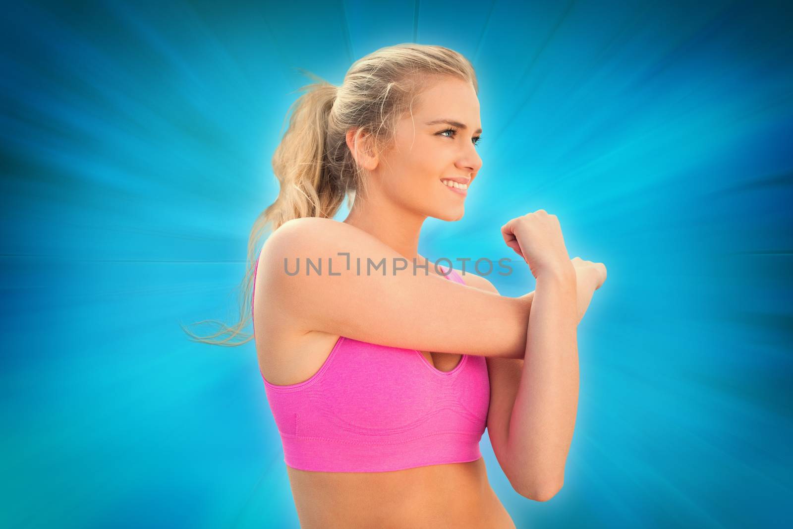 Smiling toned woman exercising on beach against abstract background