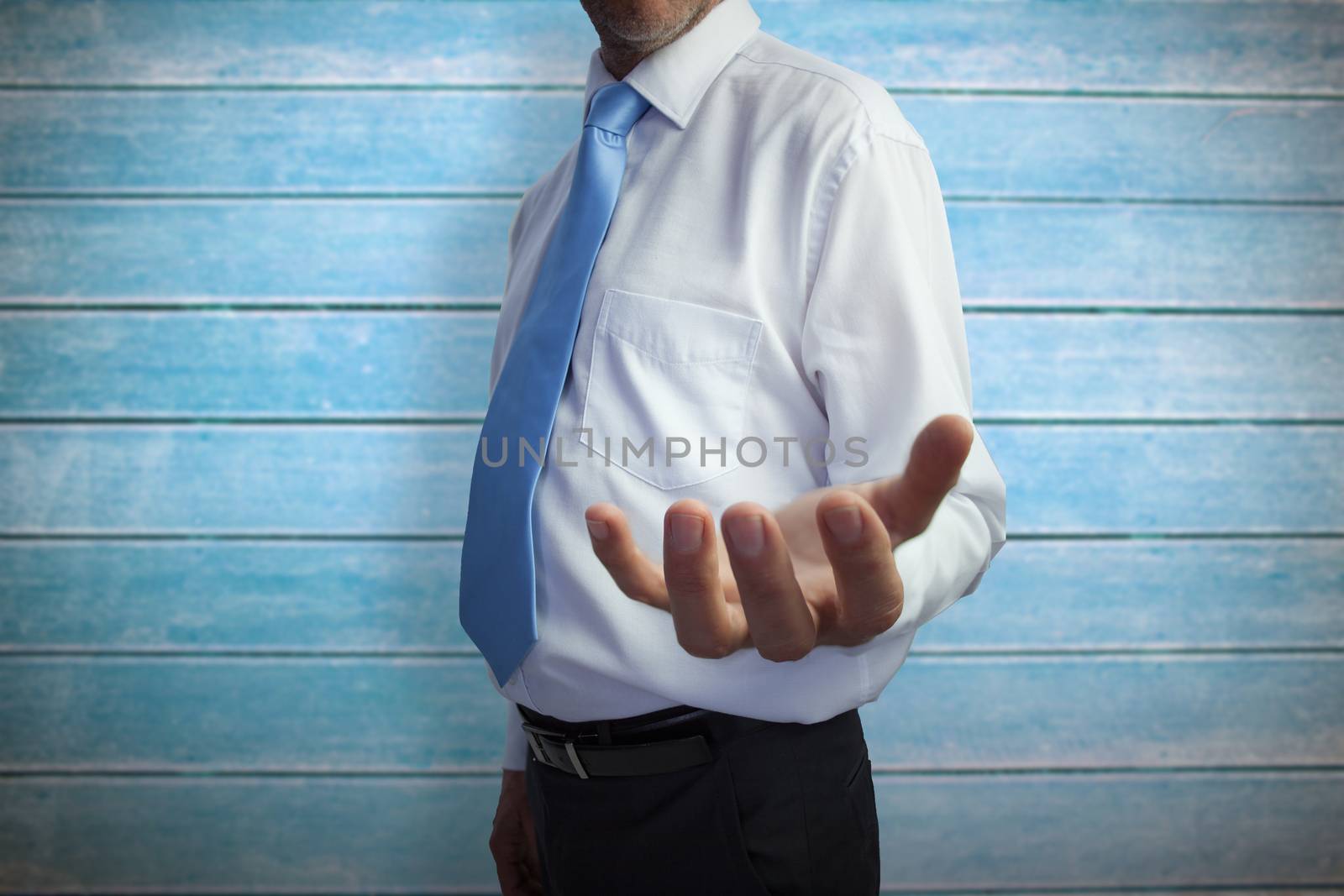 Businessman holding hand out against wooden planks
