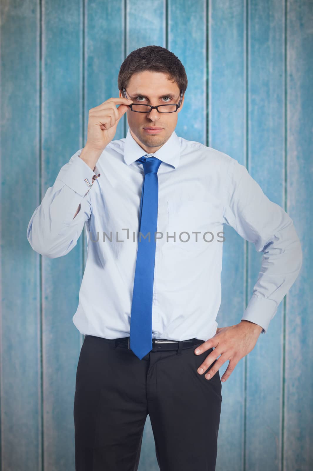 Thinking businessman tilting glasses against wooden planks