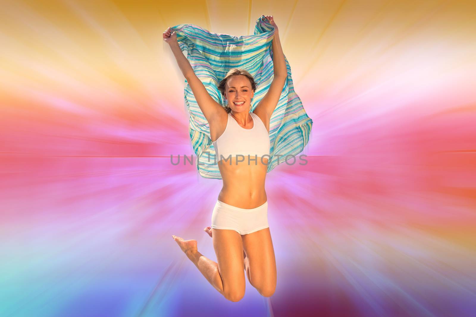 Gorgeous fit blonde jumping with scarf against abstract background