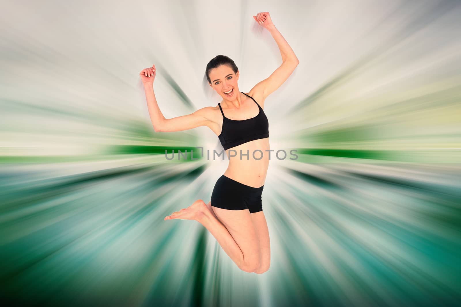 Full length of a sporty young woman jumping against abstract background