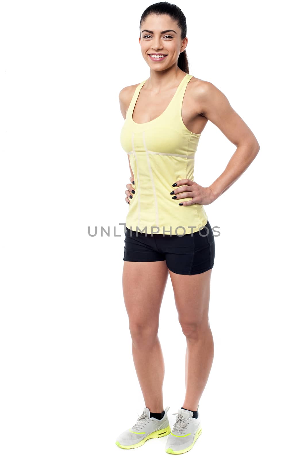Full length of athletic woman with hands on waist