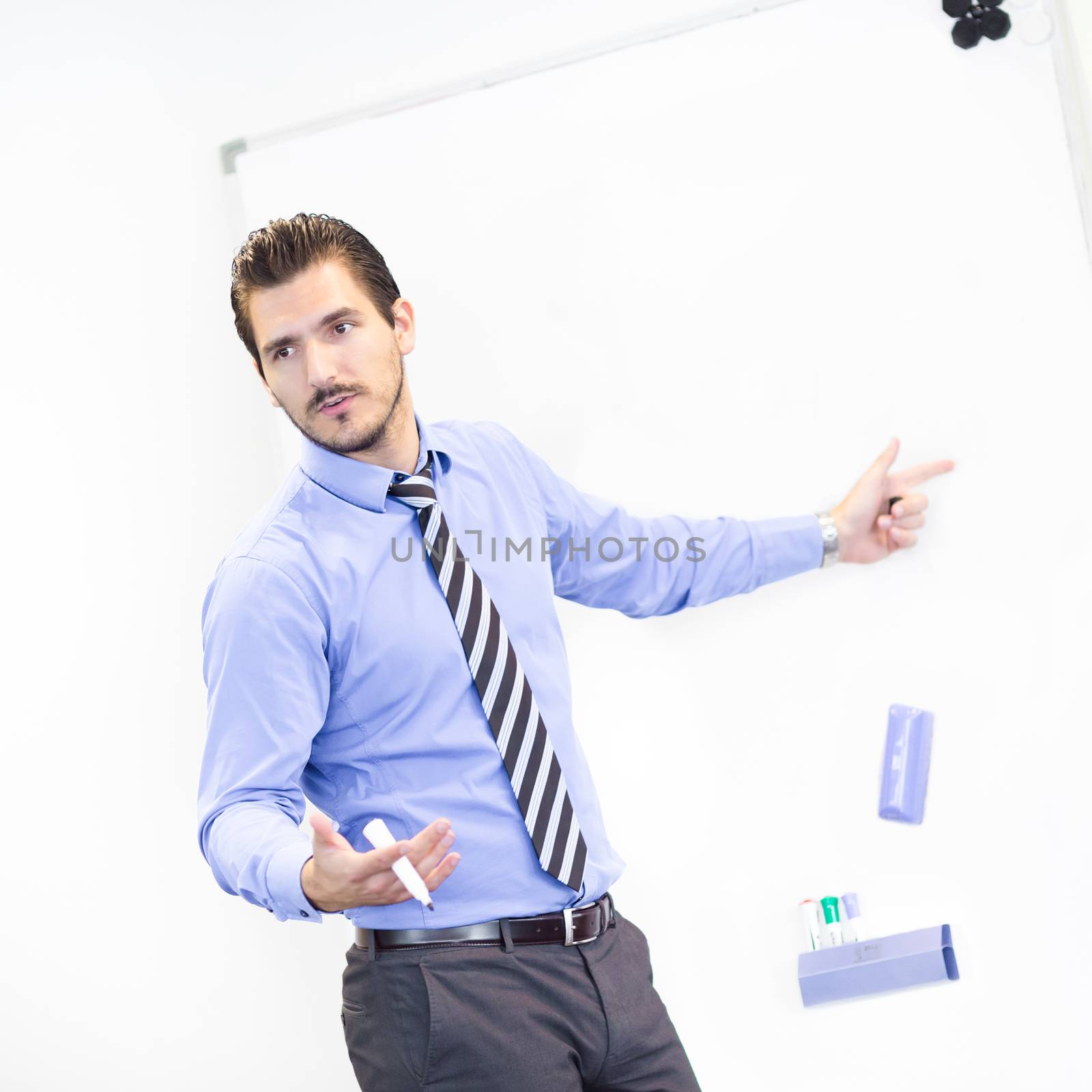 Business man making a presentation in front of whiteboard. Copy space.