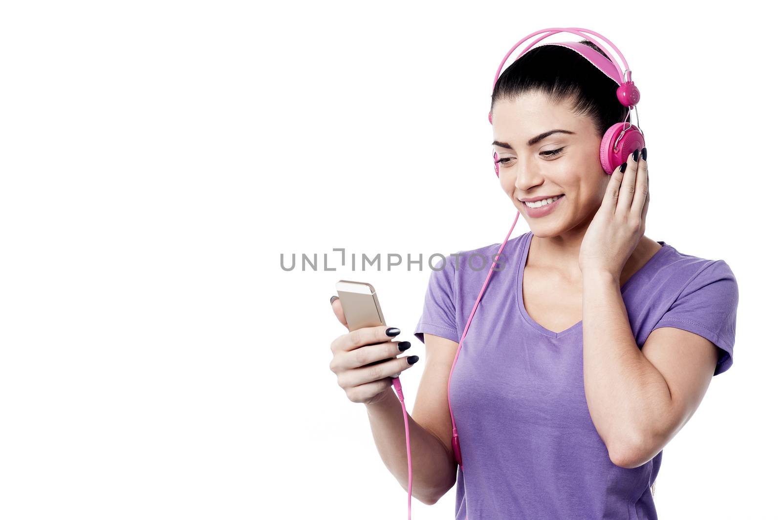 Happy woman listening music from her cell phone