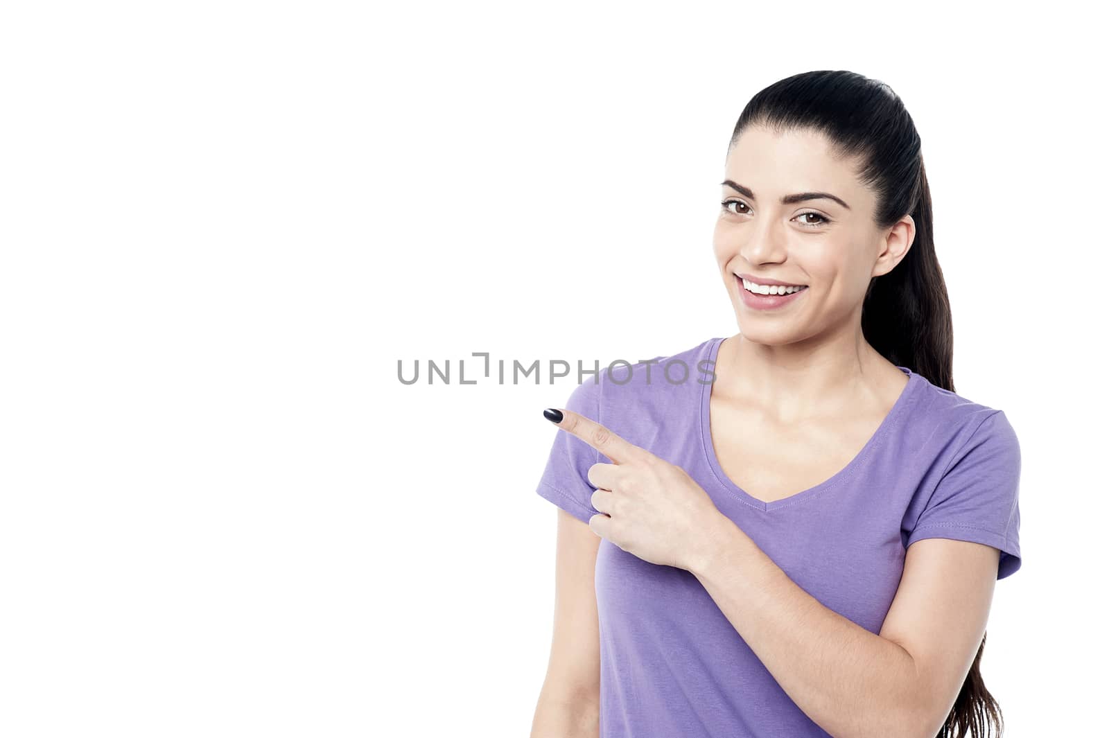 Young woman pointing at copy space