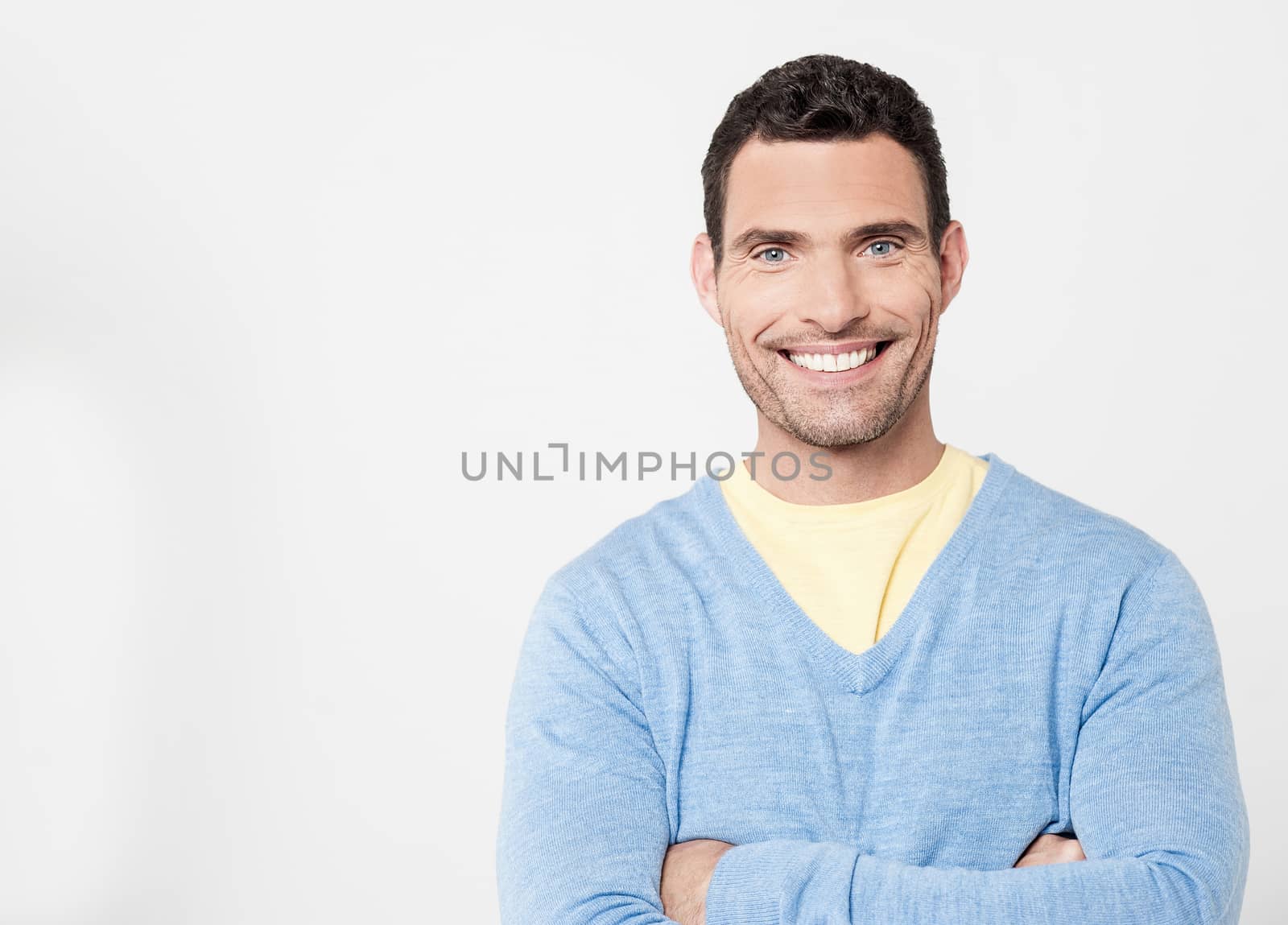 Cheerful handsome man with arms crossed