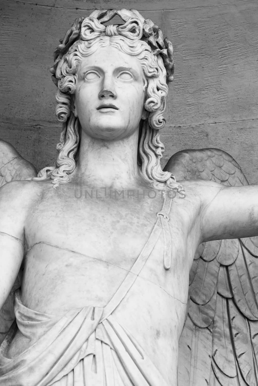 detail of a marble statue depicting an angel with wings