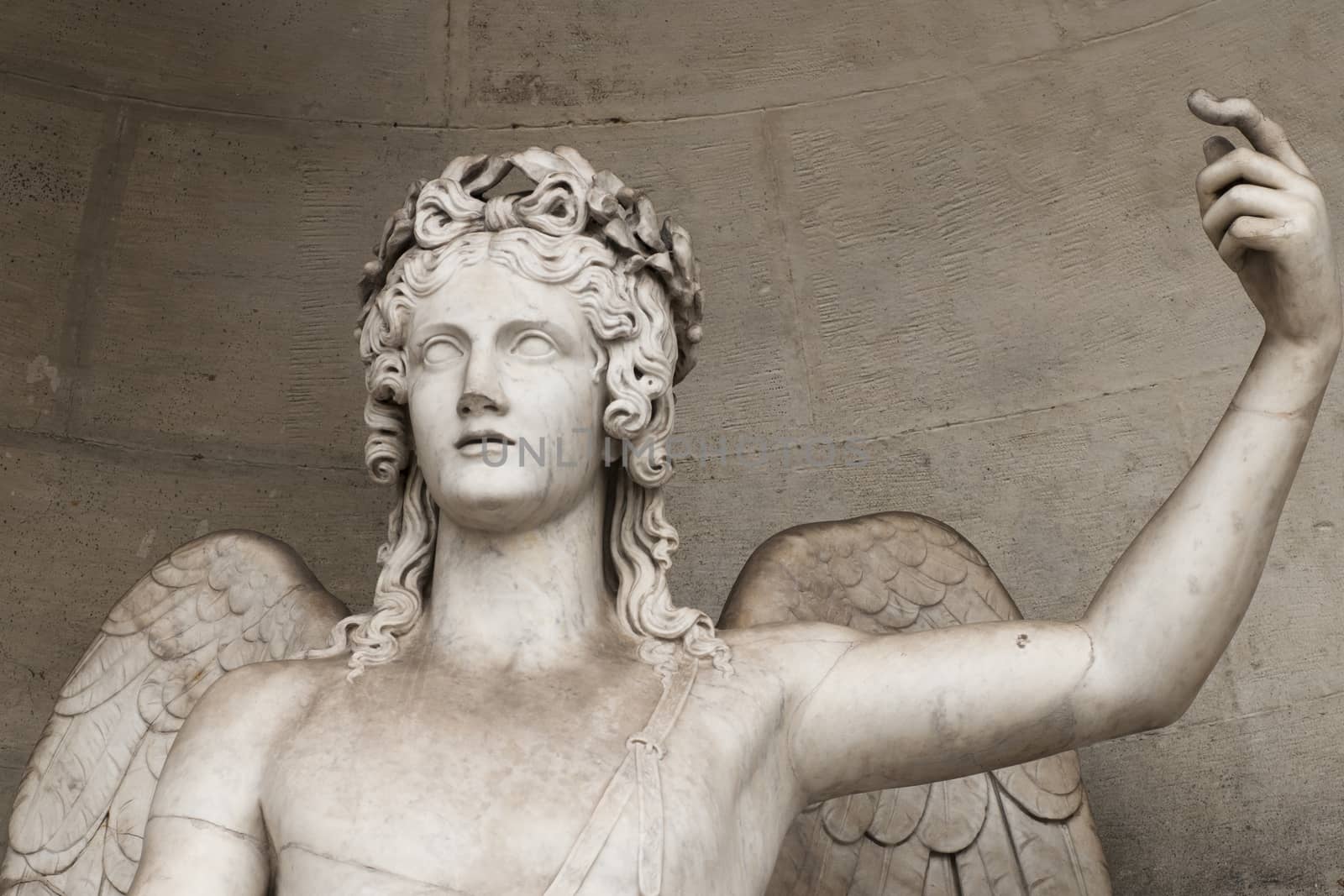 detail of a marble statue depicting an angel with wings