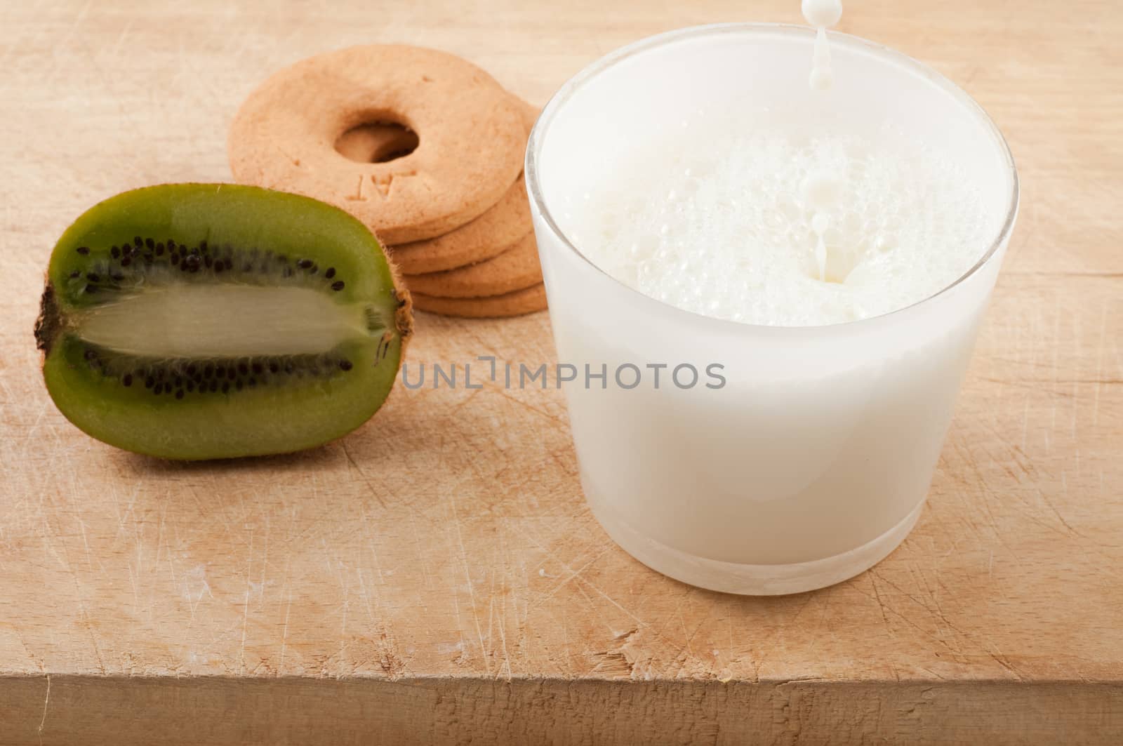 Breakfast with milk and cookies and kiwi