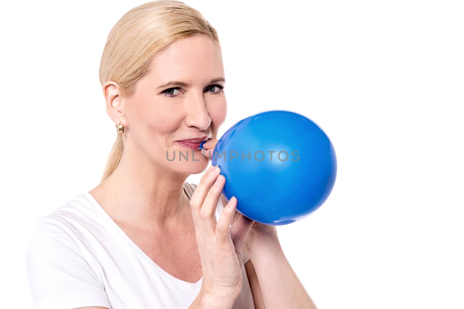 Beautiful woman blowing a blue balloon