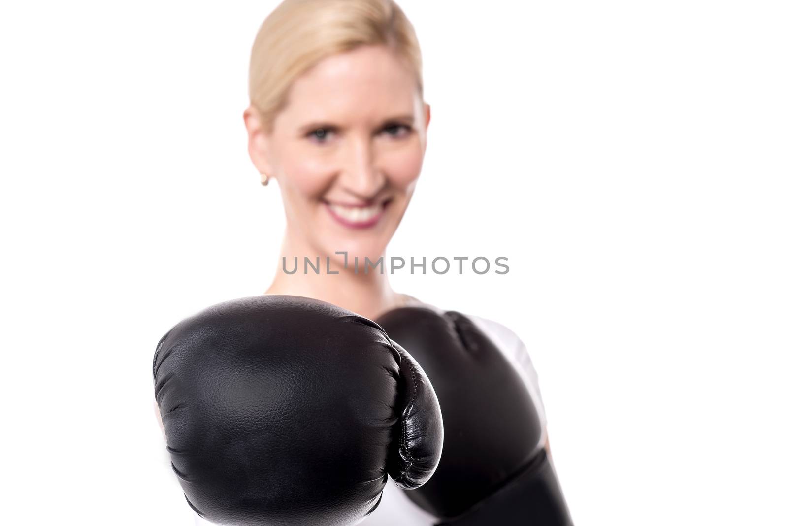 Closeup of woman posing with black boxing gloves