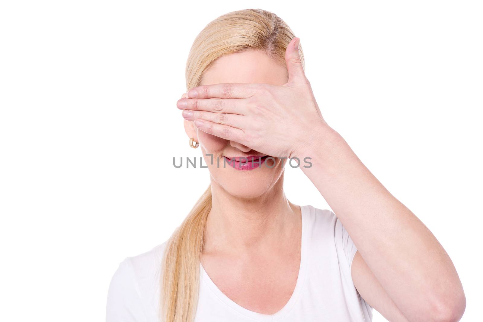 Shy woman covering her eyes with her hand