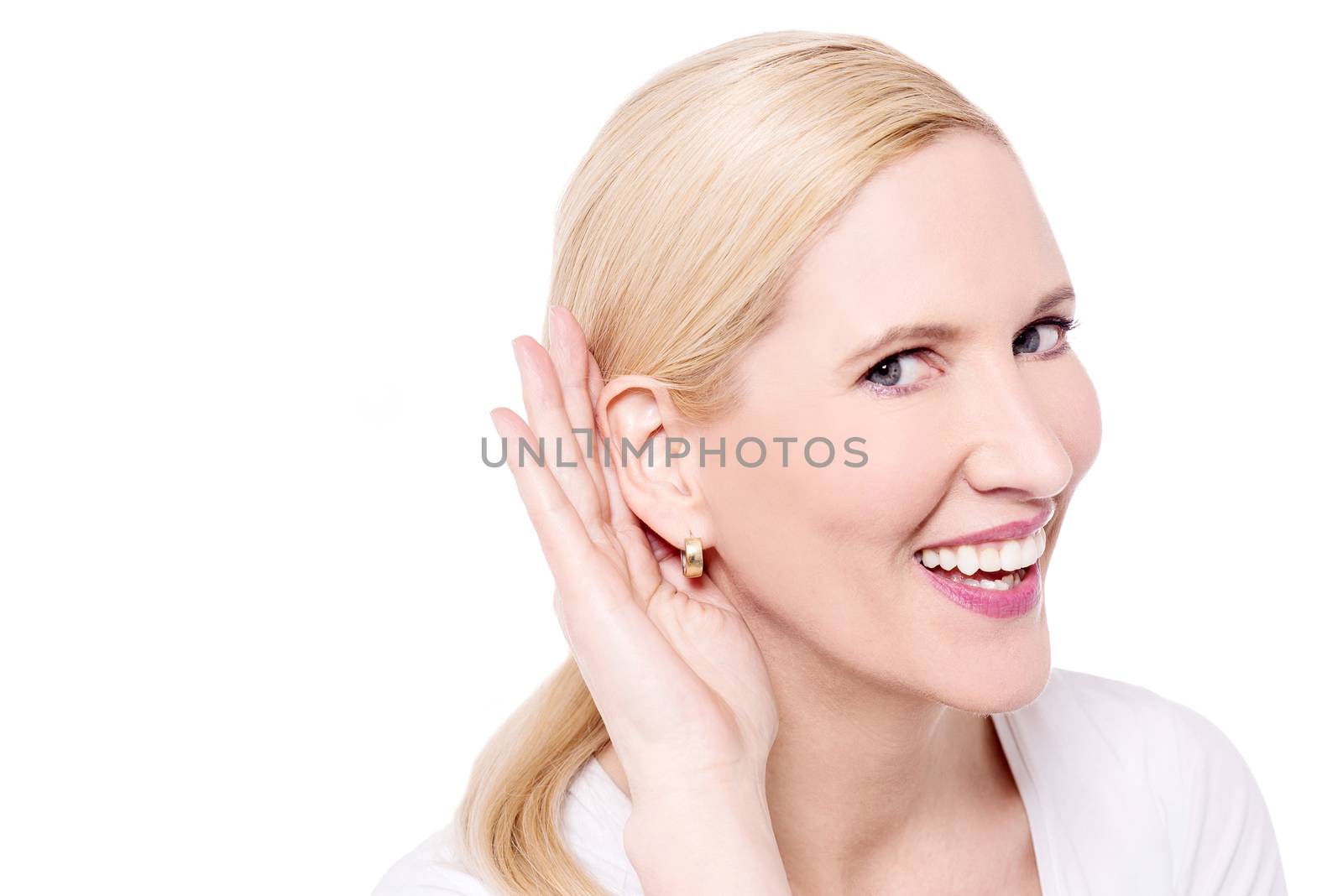 Listening woman holds her hand near ear 