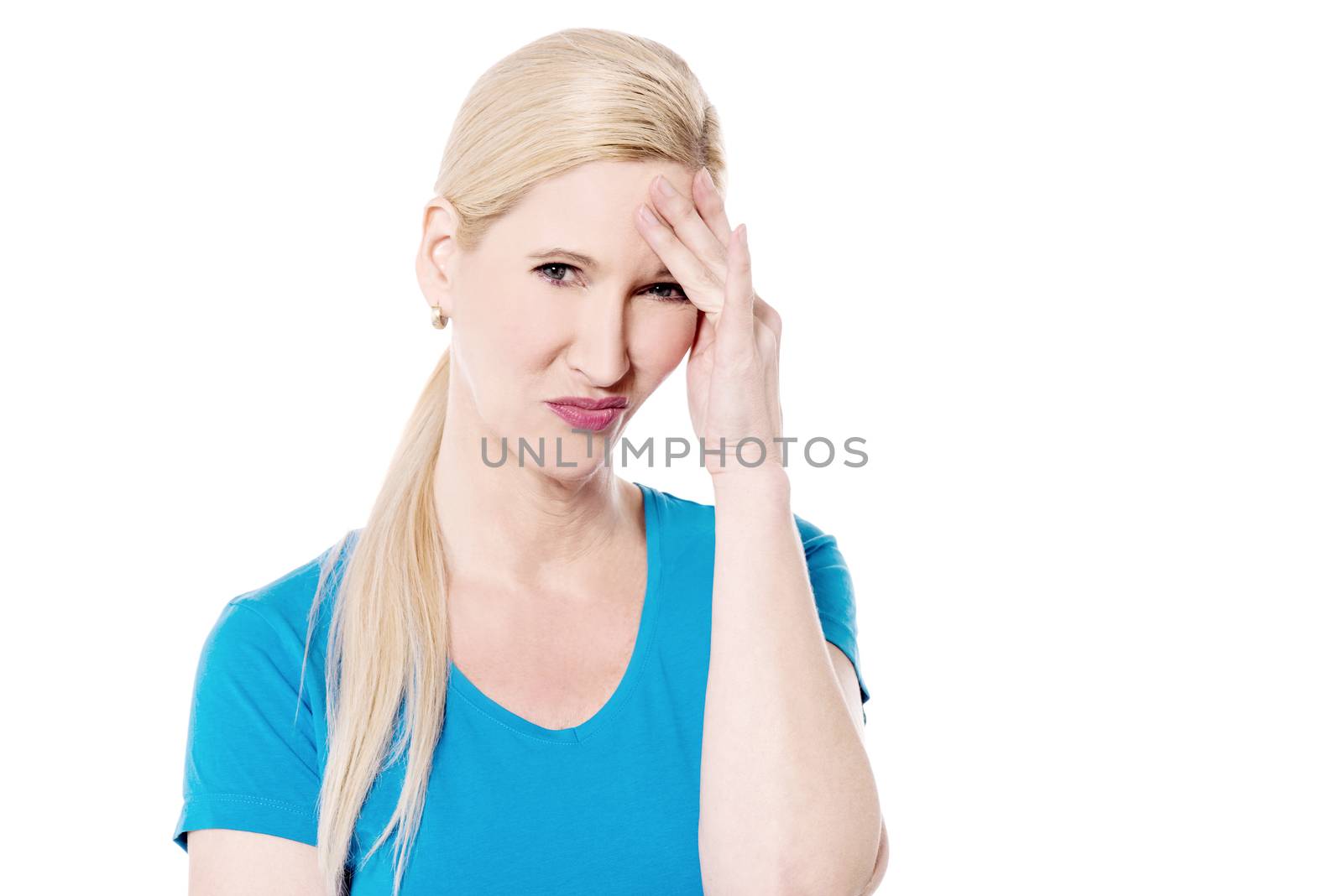 Depressed woman holding hand to forehead