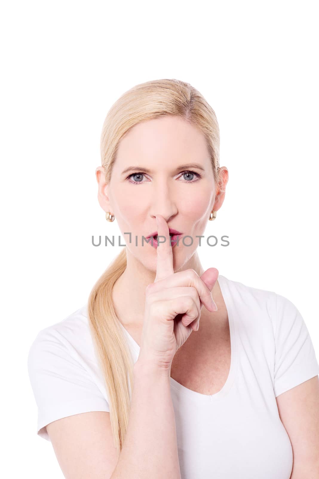 Beautiful woman keeping finger on her lips