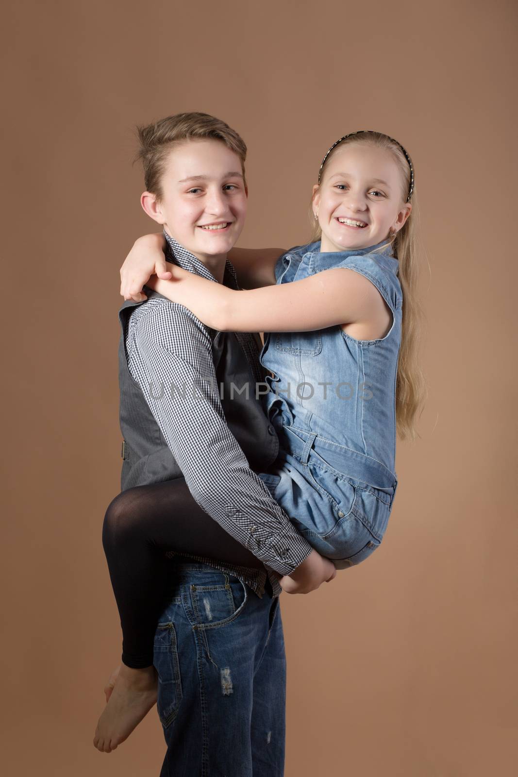 Fashion smiley european siblings posing by artush