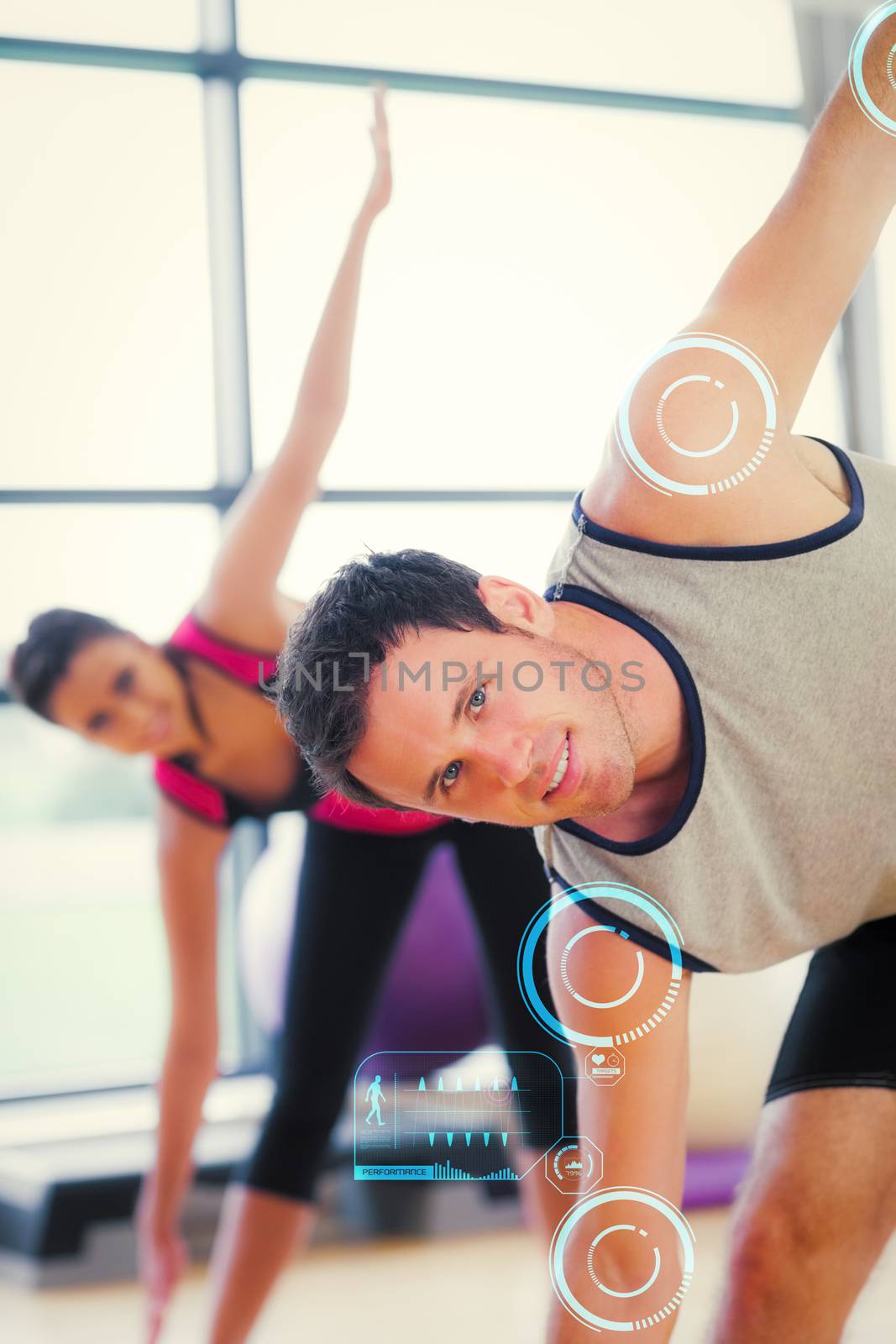 Two sporty people stretching hands at yoga class against fitness interface