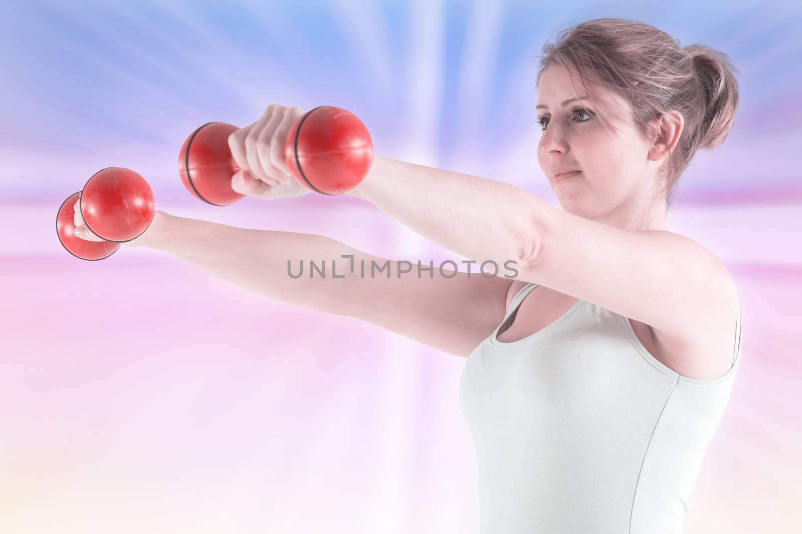 Woman holding weights against abstract background
