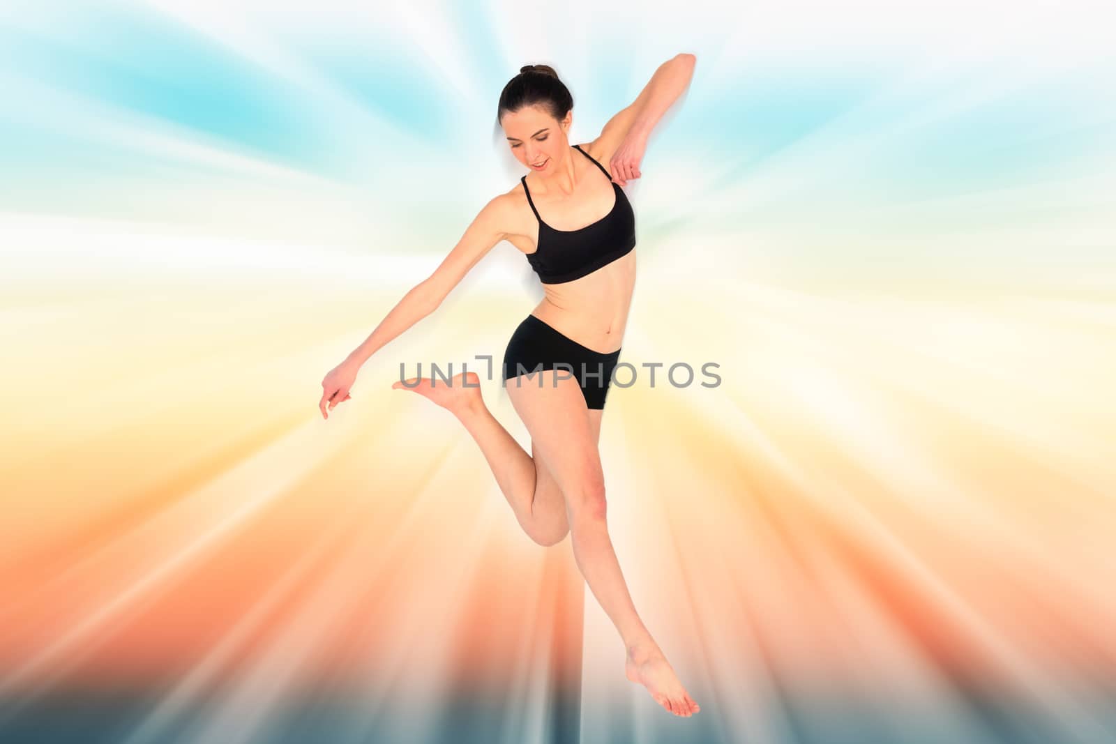 Full length of a sporty young woman jumping against abstract background