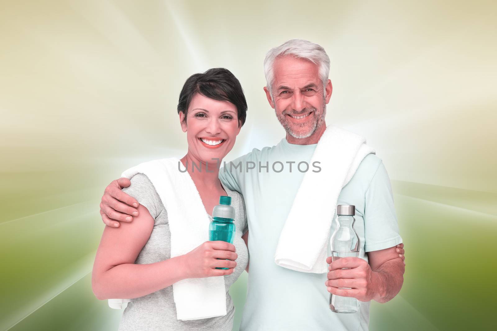 Portrait of a happy fit couple against abstract background