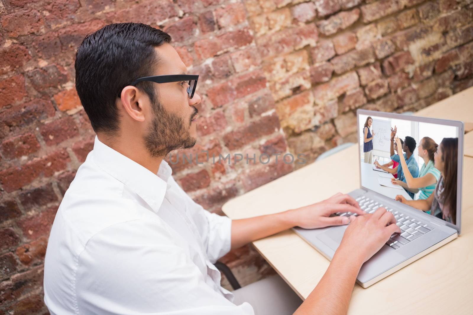 Composite image of casual business people in office at presentation by Wavebreakmedia