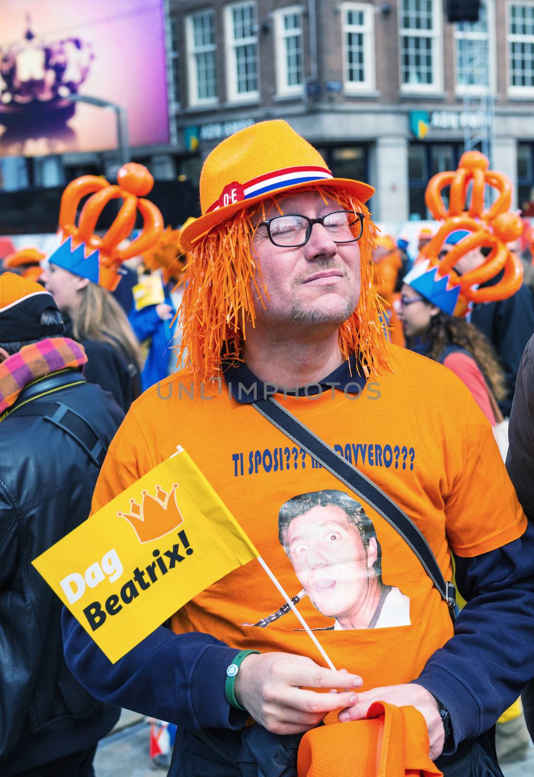 AMSTERDAM - APRIL 30: City natives and tourists celebrate Queen's Day, Dutch annual national holiday, in the streets of the city, on April 30, 2013 in Amsterdam, The Netherlands.
