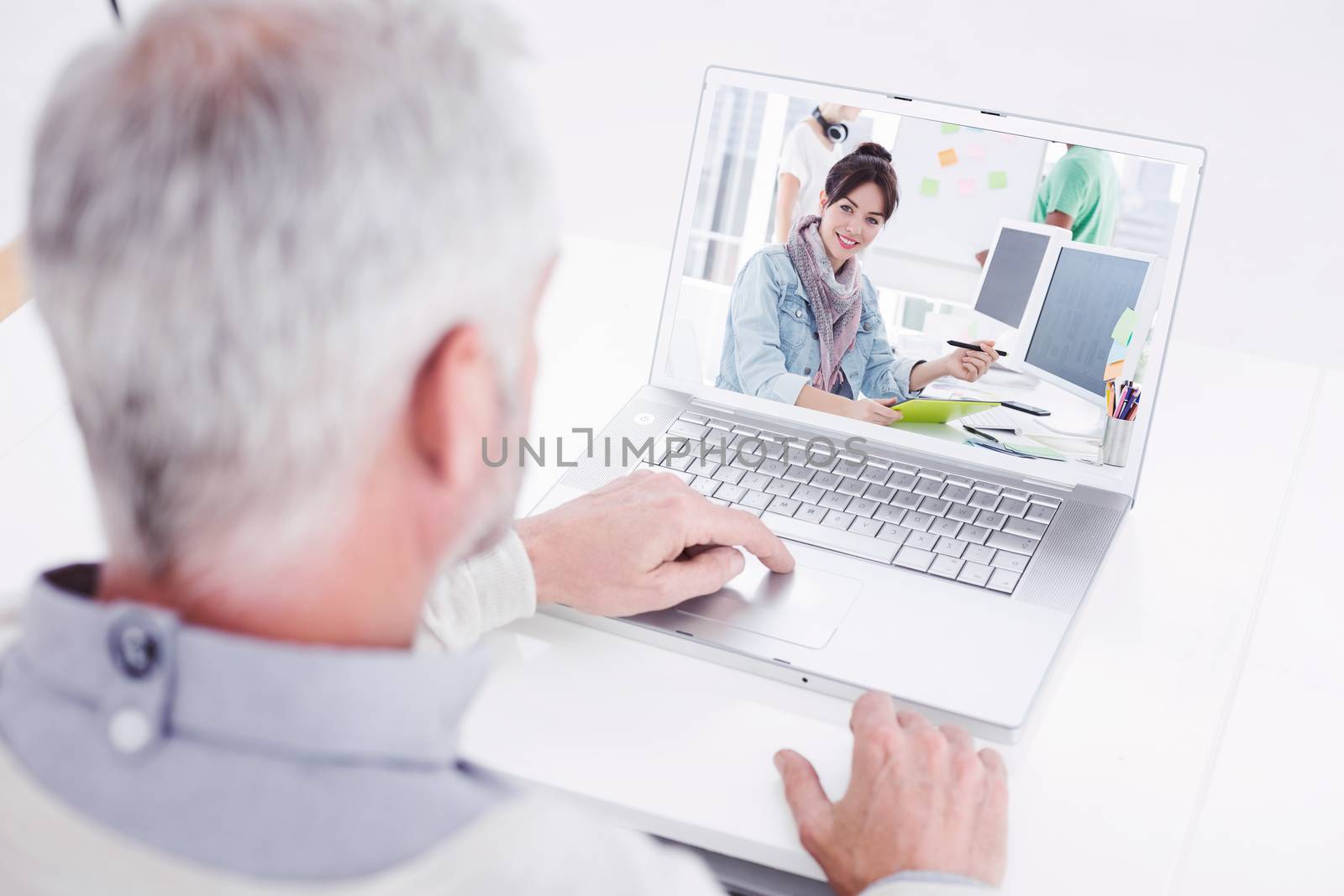 Composite image of closeup rear view of a grey haired man using laptop at desk by Wavebreakmedia