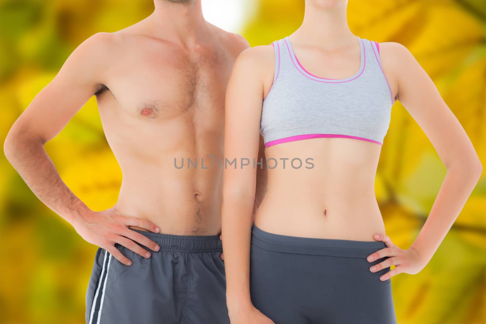 Mid section of a fit young couple against autumnal leaves against blurred plants