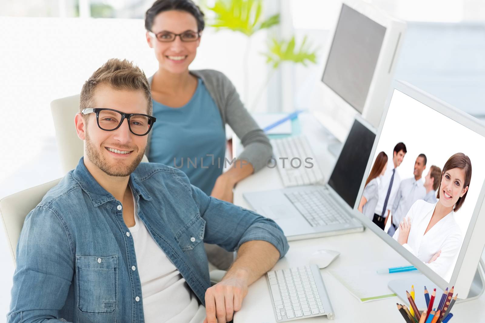 Composite image of confident manager in front of her team with folded arms by Wavebreakmedia