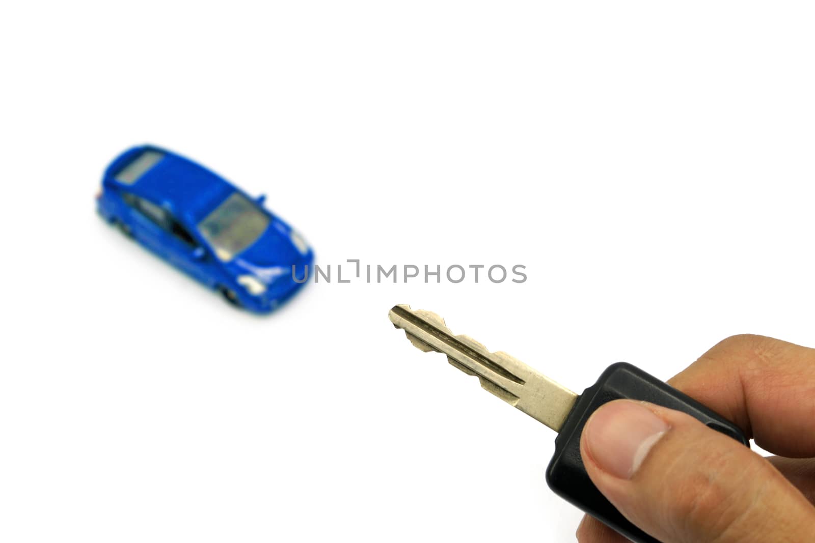 Right hand holding car key and car model for business concept by mranucha