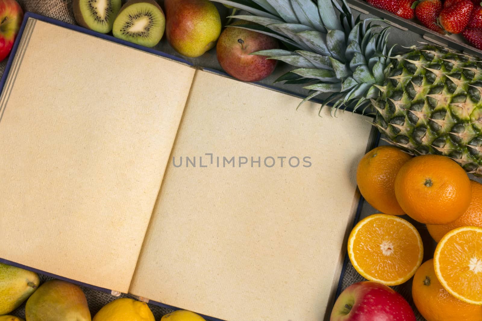 A selection of fresh fruit and a recipe book - Space for text