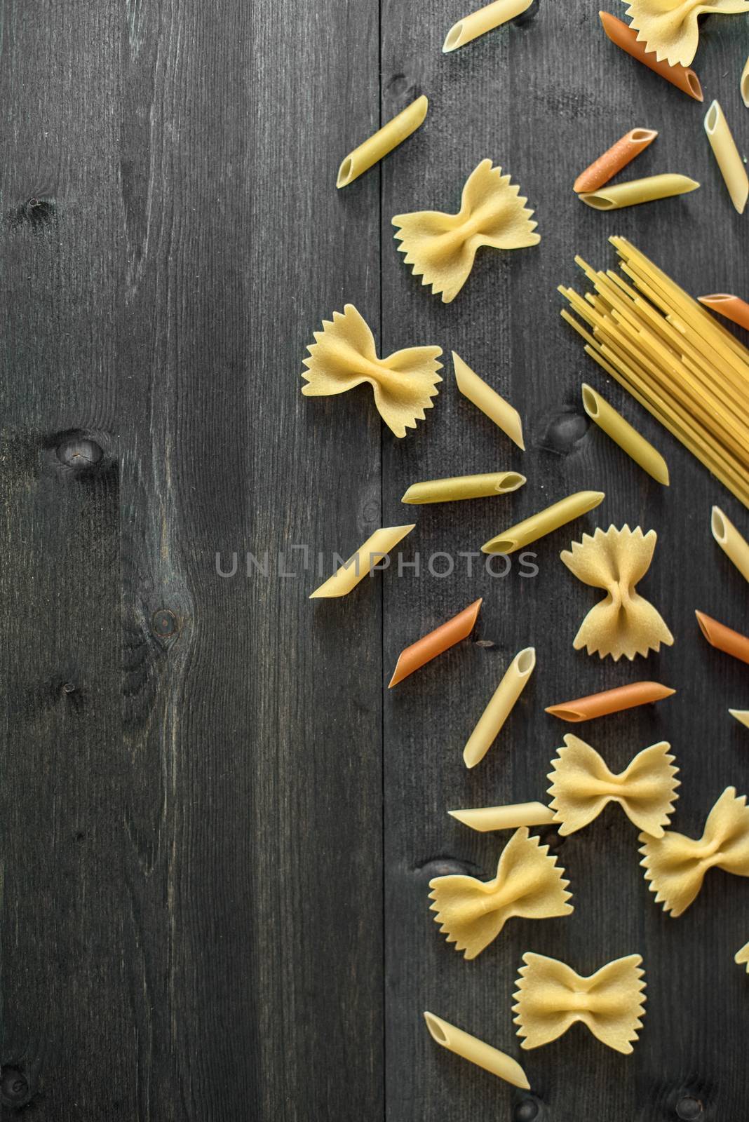 Pasta collection on rustic dark wooden background