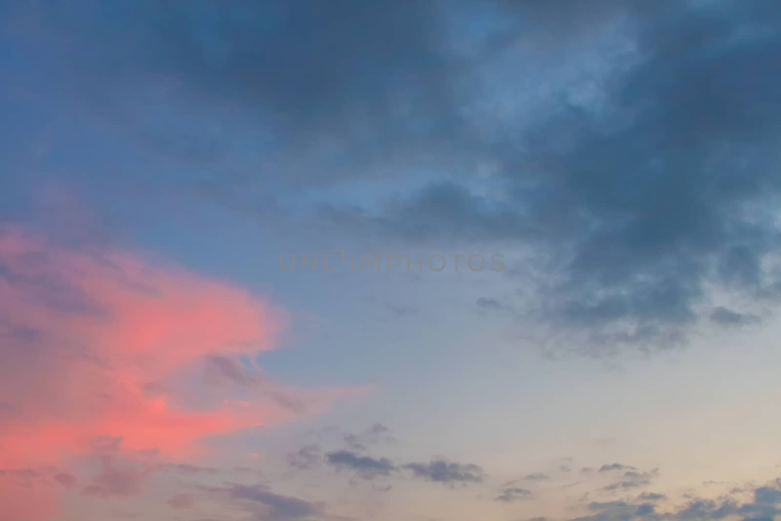 Clouds on blue sky background at sundown