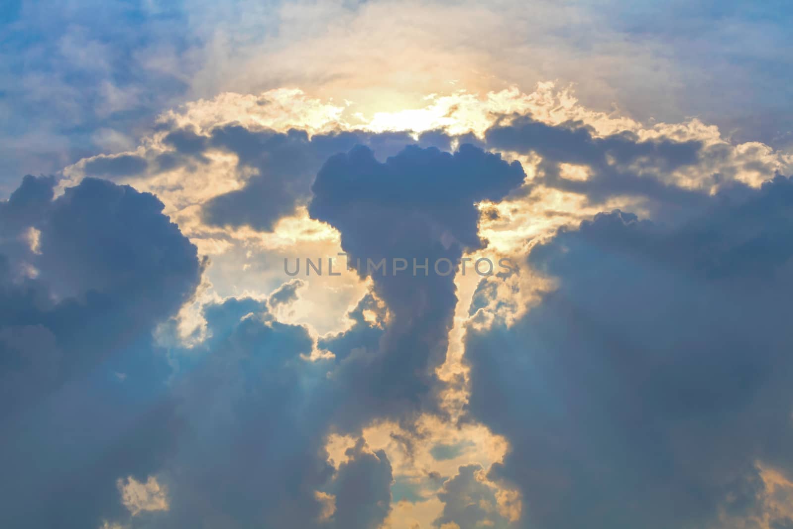 Sun under clouds on blue sky background