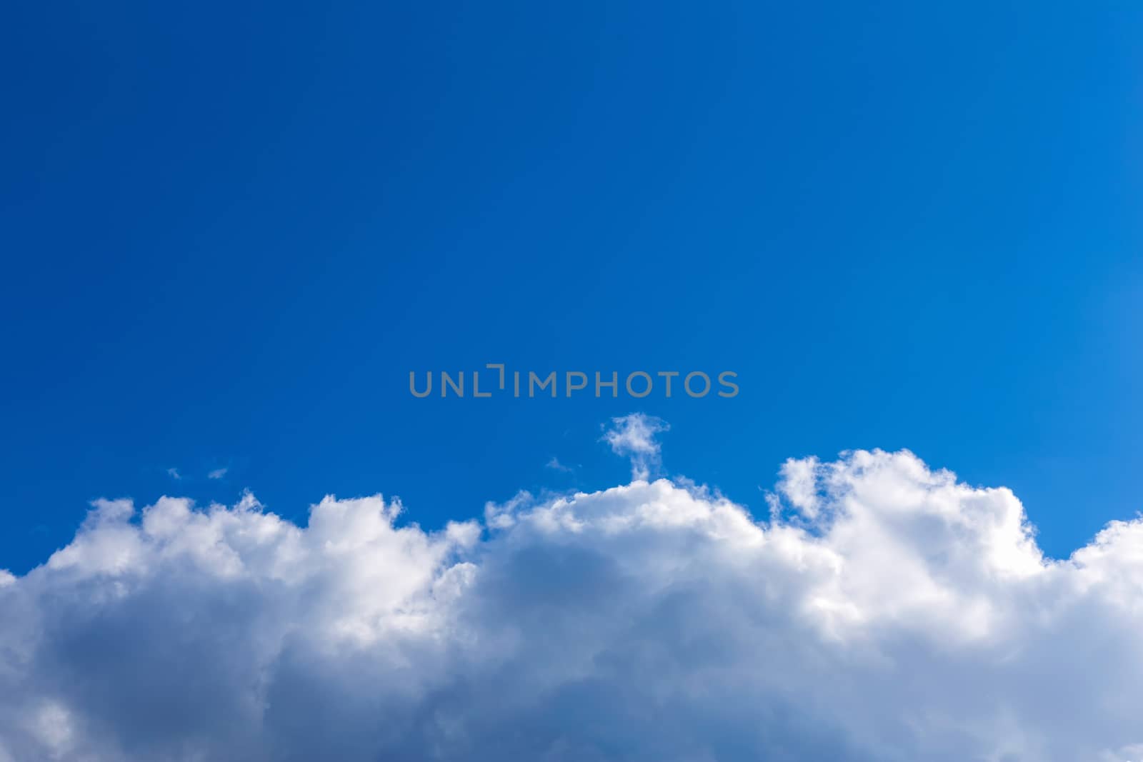White fluffy clouds on blue sky background