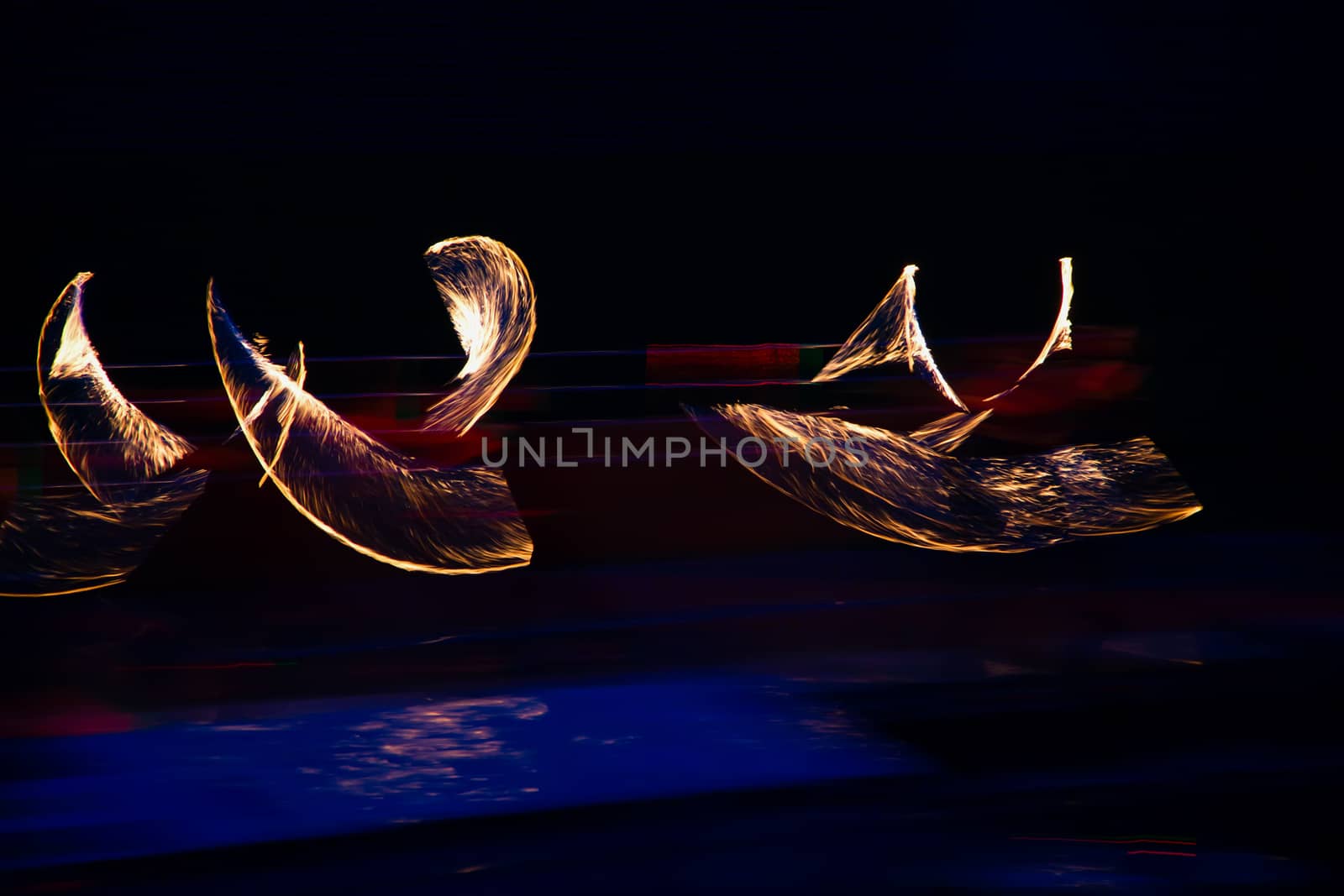 Fire performers in motion at night