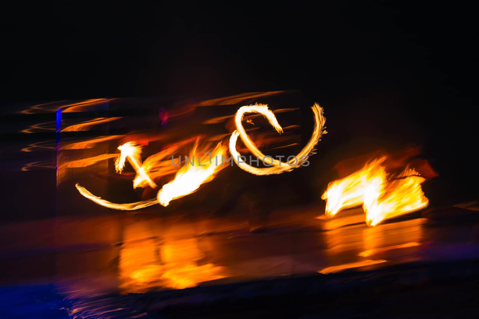 Fire performers in motion at night