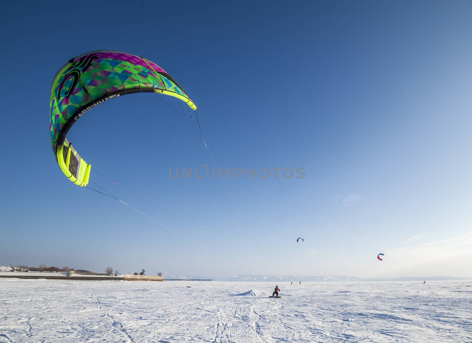 Kiteboarder with kite on the snow by H2Oshka