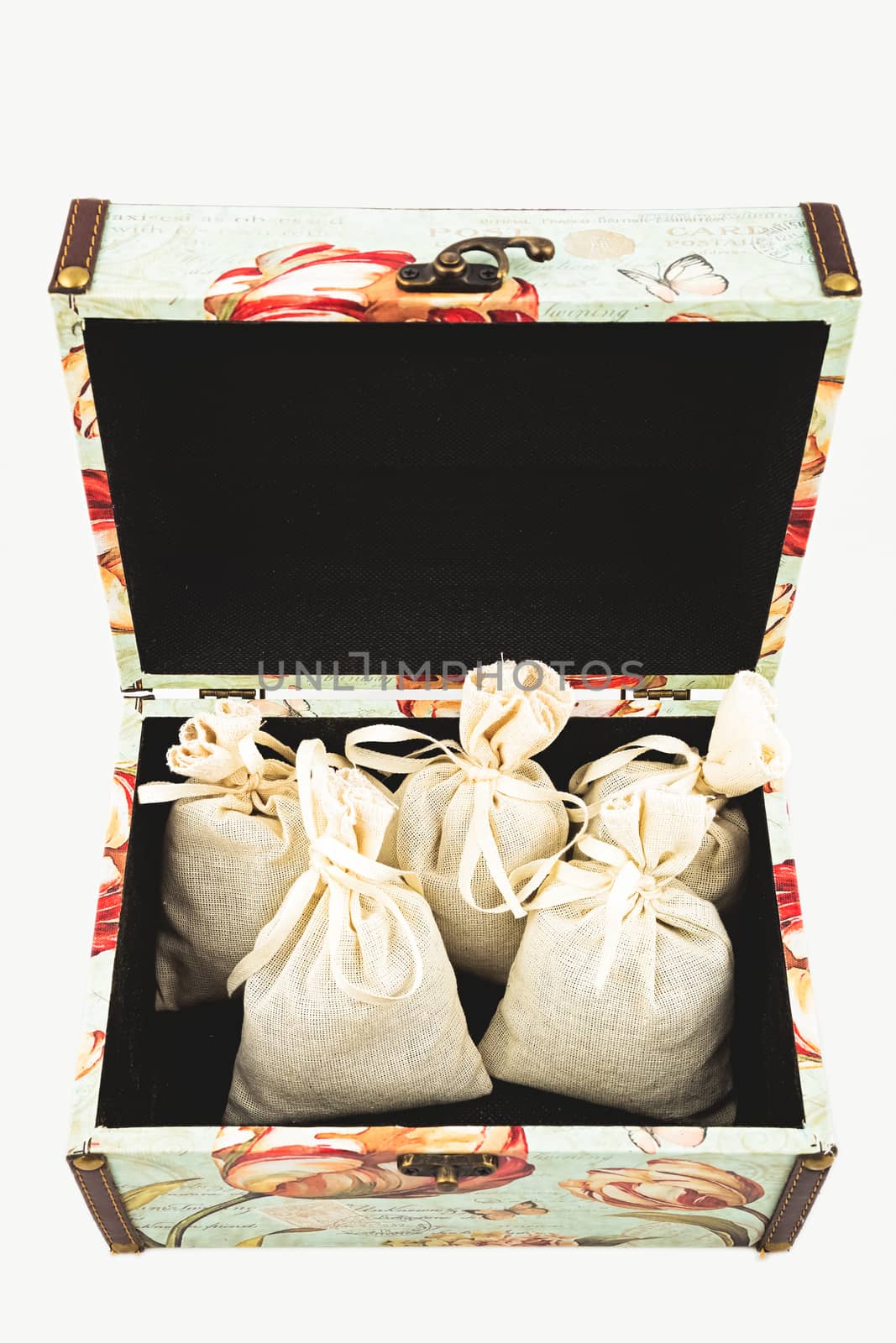 Gift box with textile pouches on white background