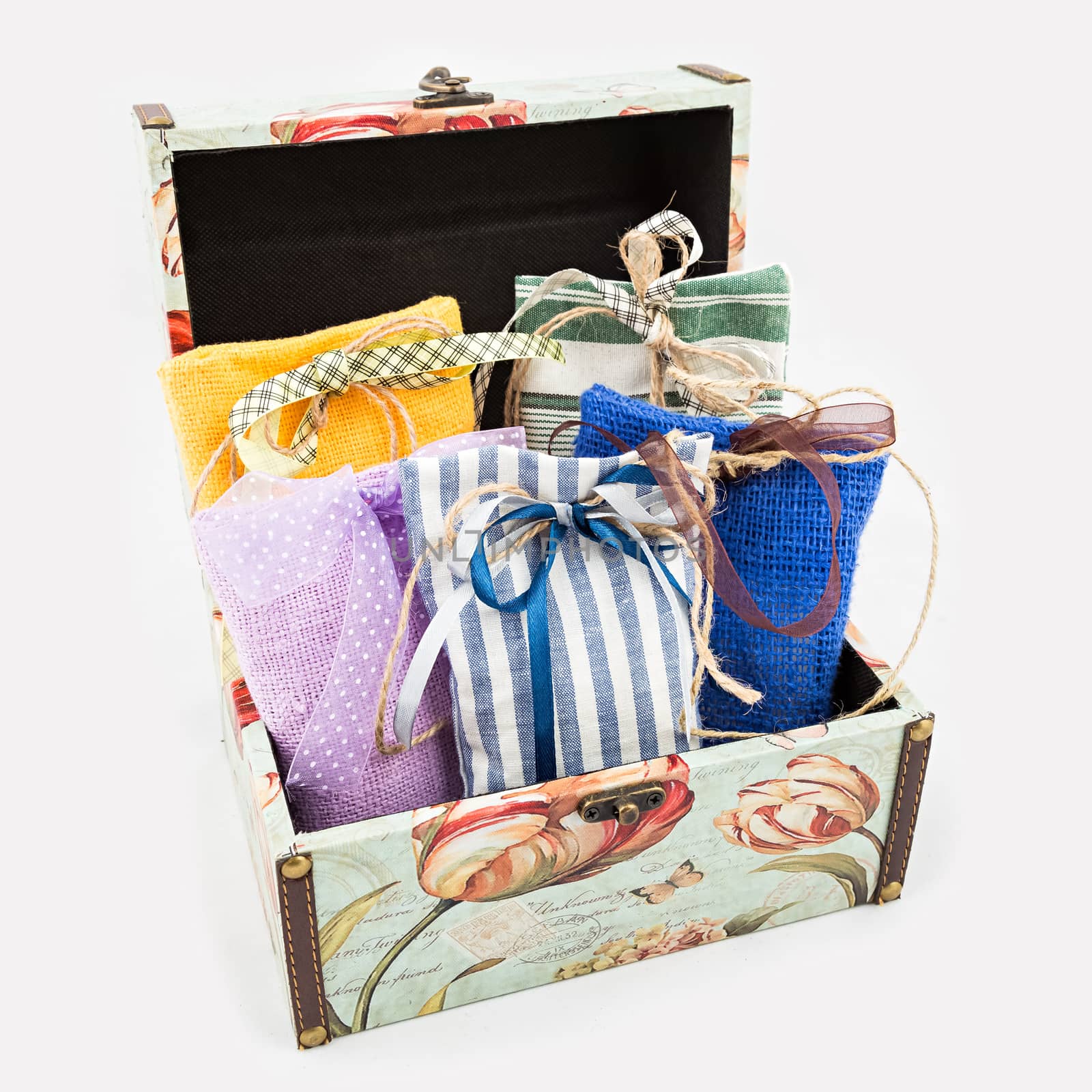 Decorative textile sachet pouches in gift box on white background