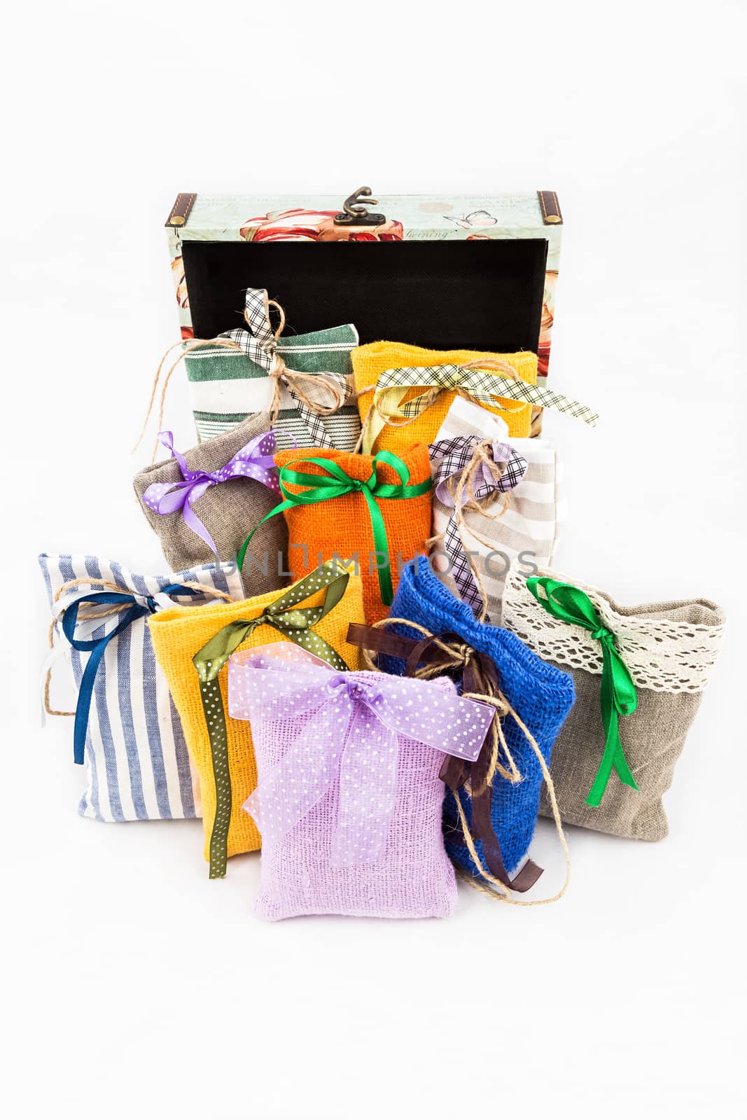 Decorative textile sachet pouches with gift box on white background