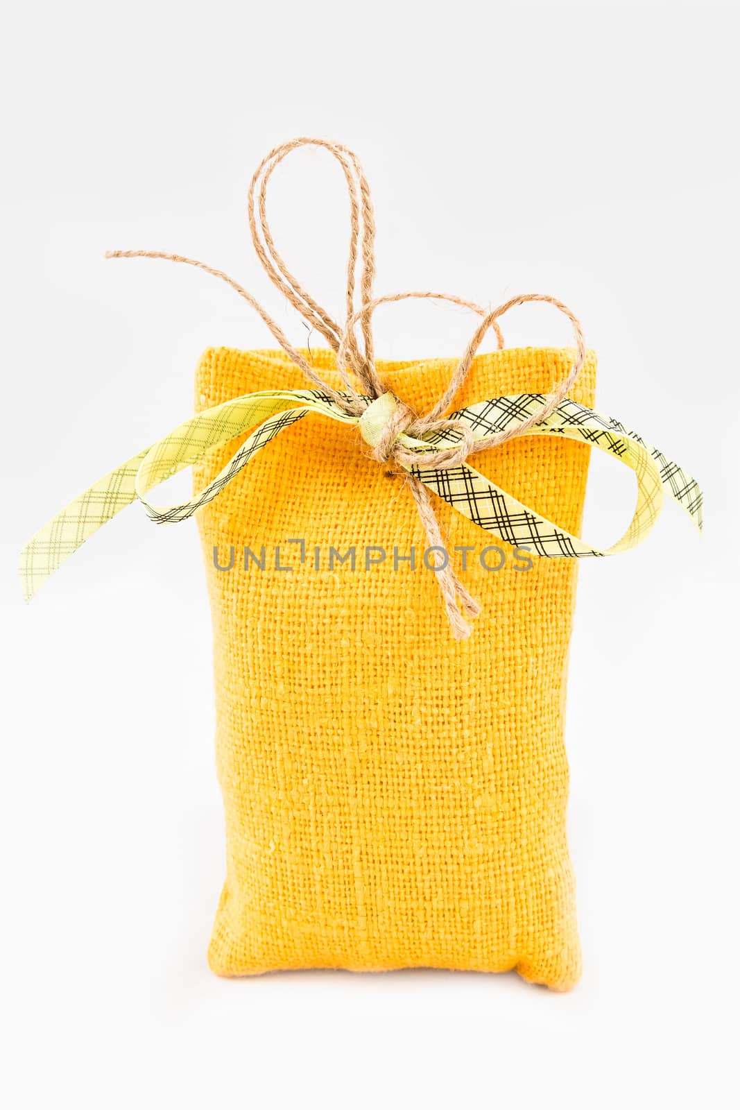 Decorative textile sachet pouch with a ribbon and bow on white background