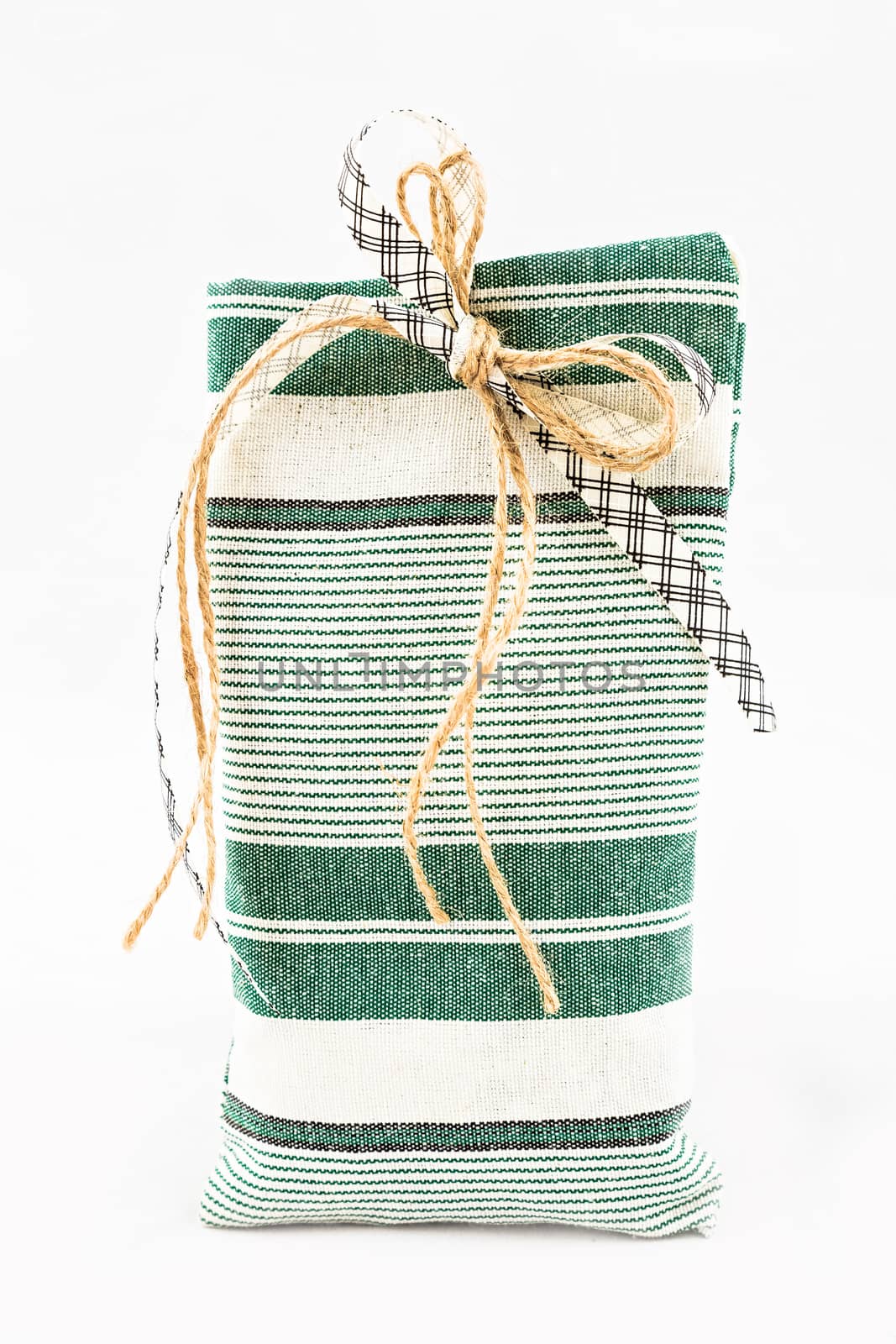 Decorative textile sachet pouch with a ribbon and bow on white background