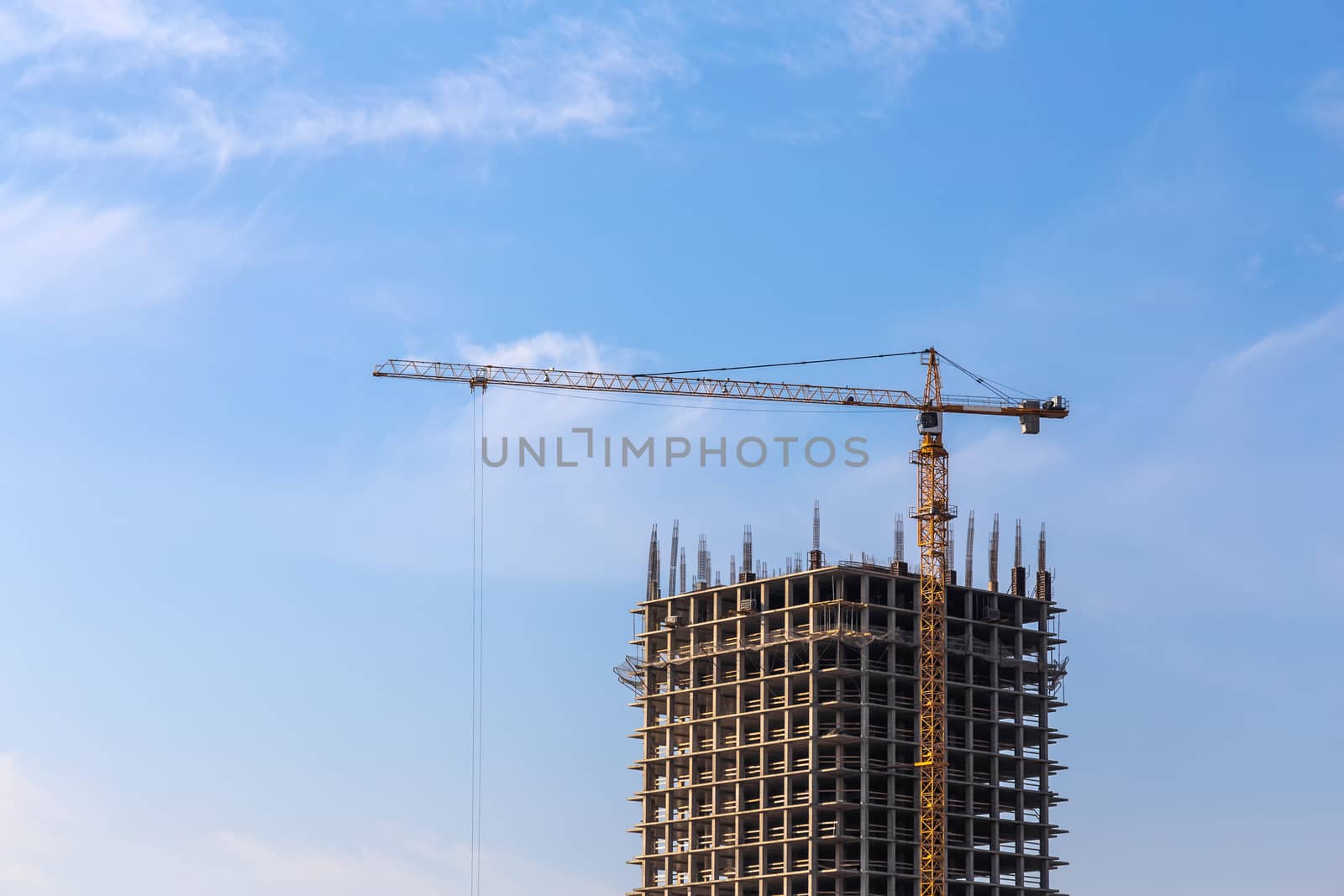 Construction crane on building site on sky background