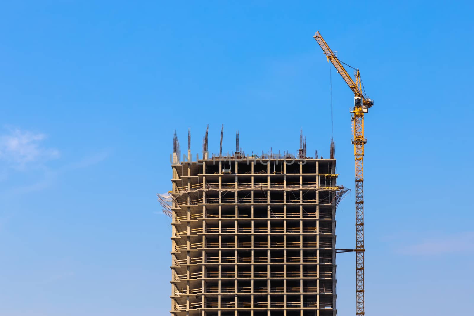 Construction crane on building site on sky background