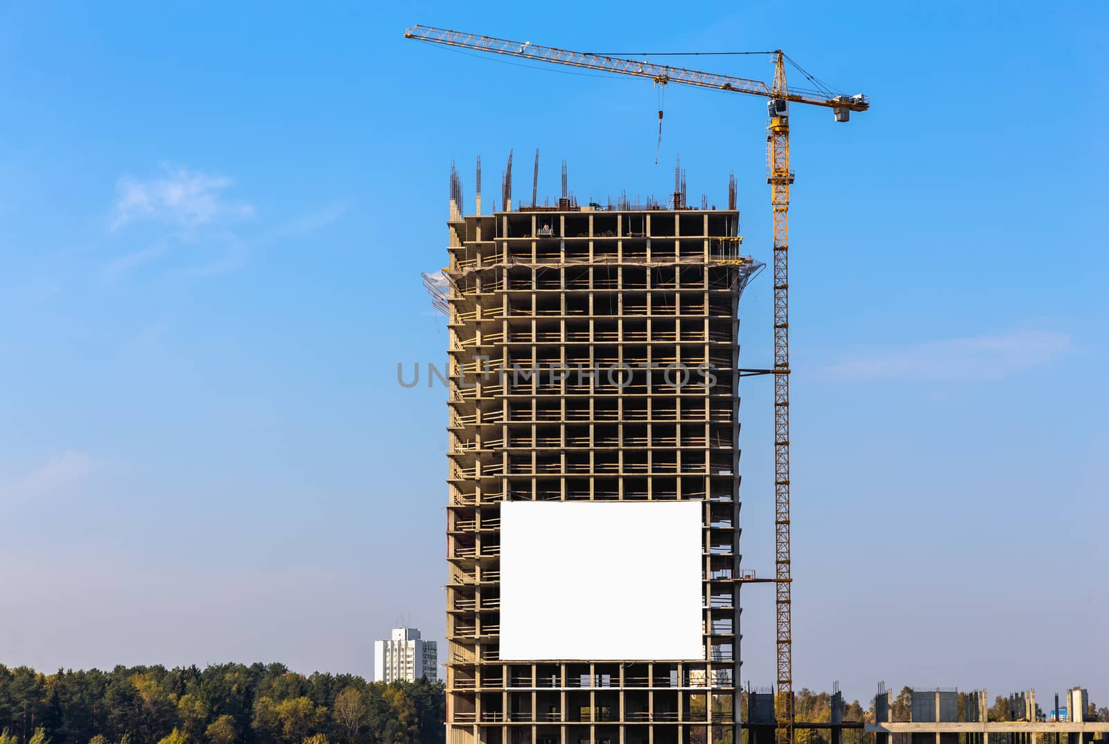 Construction crane on building site on sky background