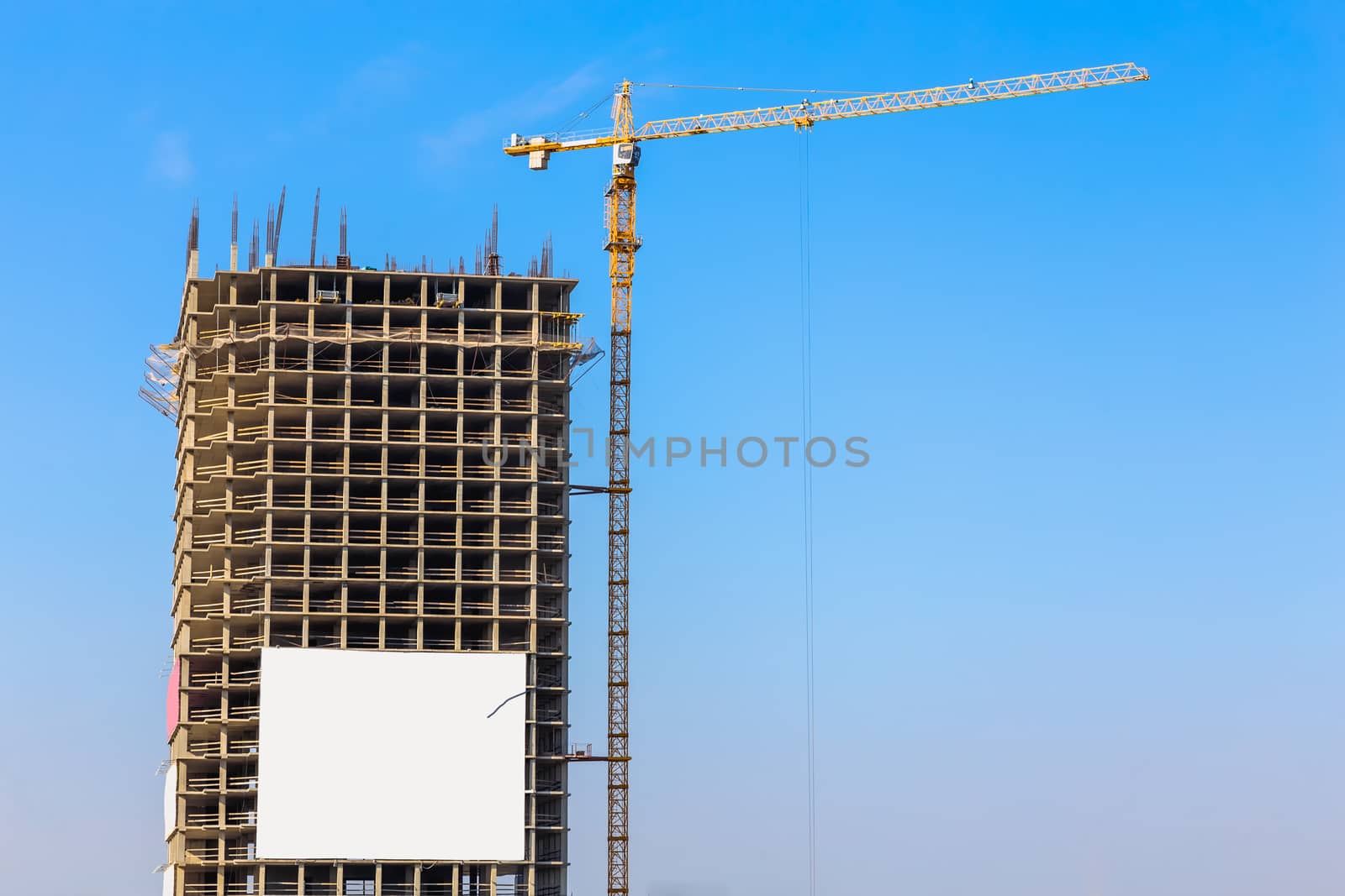 Construction crane on building site on sky background